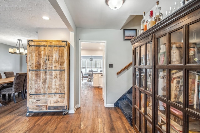 58 Circle Dr, Syosset, NY 11791 - hallway featuring stairs, dark wood-style flooring, and a textured ceiling