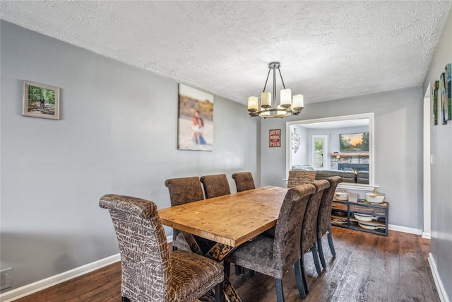 58 Circle Dr, Syosset, NY 11791 - dining room with a chandelier, dark wood-type flooring, and a textured ceiling