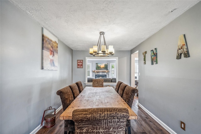 58 Circle Dr, Syosset, NY 11791 - dining room featuring a chandelier, a textured ceiling, and dark wood-type flooring