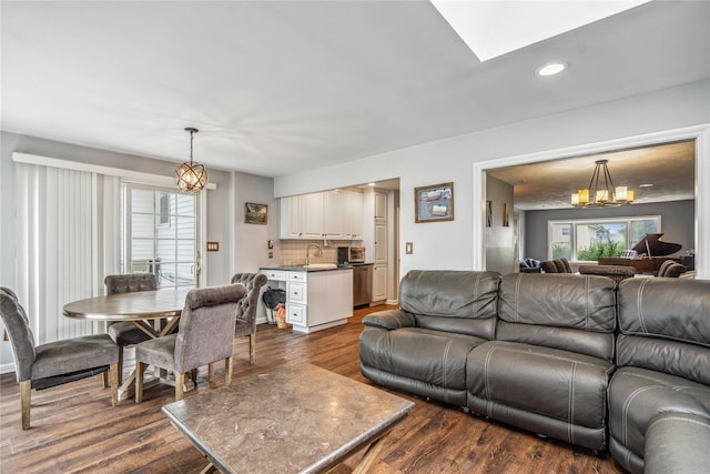 58 Circle Dr, Syosset, NY 11791 - living area featuring dark wood-type flooring, a chandelier, recessed lighting, and a skylight