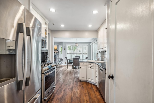 58 Circle Dr, Syosset, NY 11791 - kitchen with appliances with stainless steel finishes, dark wood finished floors, white cabinets, recessed lighting, and a peninsula