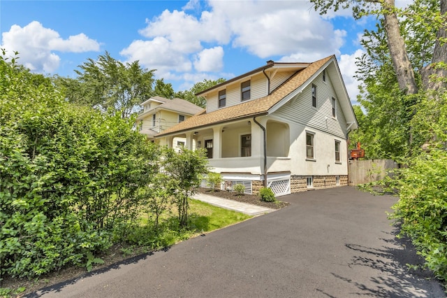 250 Cedar Hill Ave, Nyack, NY 10960 - view of front of house featuring asphalt driveway, roof with shingles, stucco siding, a chimney, and a porch