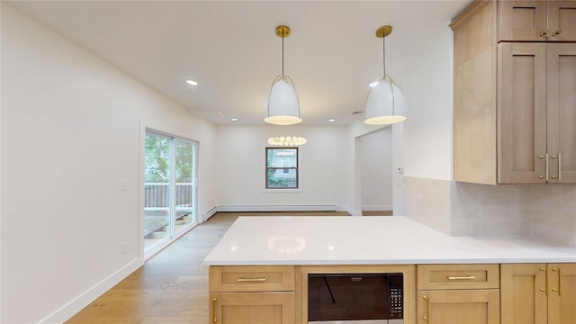 250 Cedar Hill Ave, Nyack, NY 10960 - kitchen with a baseboard radiator, light brown cabinets, light countertops, backsplash, and light wood-type flooring