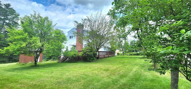 530 Sackett Lake Rd, Monticello, NY 12701 - view of green lawn featuring a wooden deck and stairs