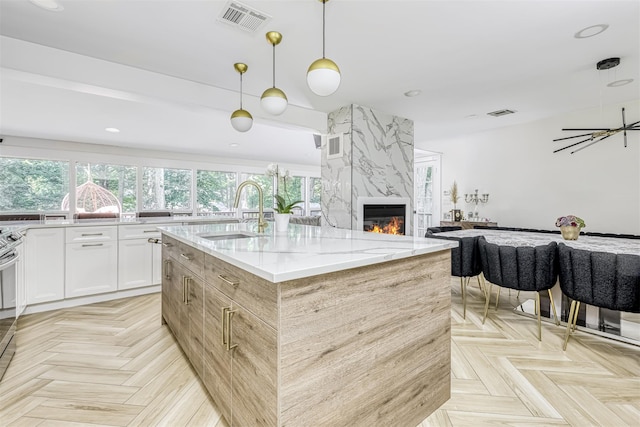 17 Onderdonk Rd, Suffern, NY 10901 - kitchen with plenty of natural light, light stone countertops, white cabinets, a center island with sink, and recessed lighting