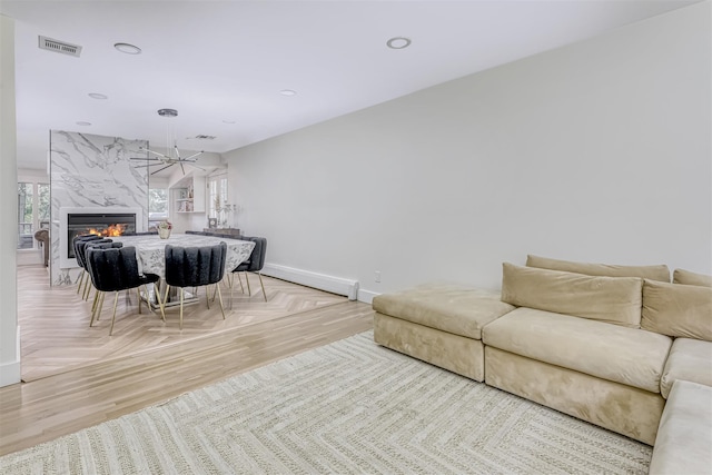 17 Onderdonk Rd, Suffern, NY 10901 - living area featuring a premium fireplace, a chandelier, recessed lighting, baseboard heating, and parquet flooring