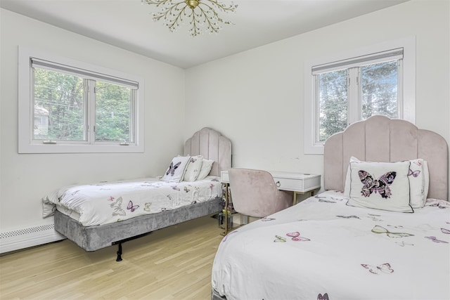 17 Onderdonk Rd, Suffern, NY 10901 - bedroom with light wood finished floors, a chandelier, and a baseboard heating unit