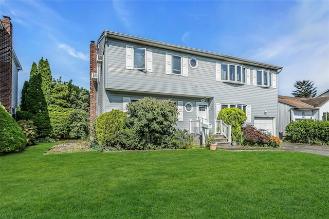 20 Wensley Rd, Plainview, NY 11803 - view of front of home featuring a chimney, a garage, a front yard, and driveway