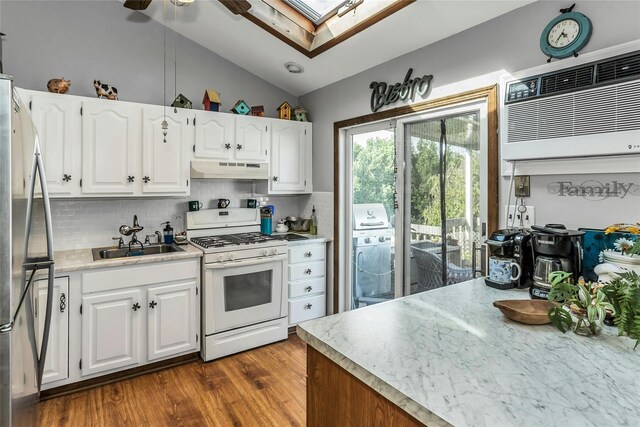20 Wensley Rd, Plainview, NY 11803 - kitchen featuring gas range gas stove, freestanding refrigerator, vaulted ceiling, under cabinet range hood, and backsplash
