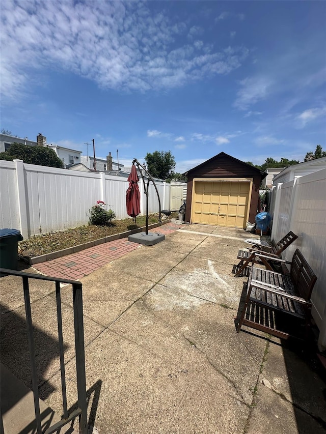 33-13 202nd St, Bayside, NY 11361 - view of patio featuring an outbuilding and a garage
