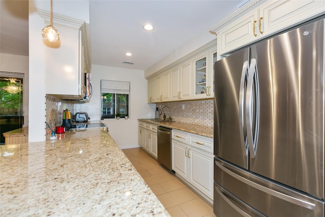 171 S Middle Neck Rd Unit 1F, Great Neck, NY 11021 - kitchen with appliances with stainless steel finishes, decorative backsplash, glass insert cabinets, light stone counters, and recessed lighting