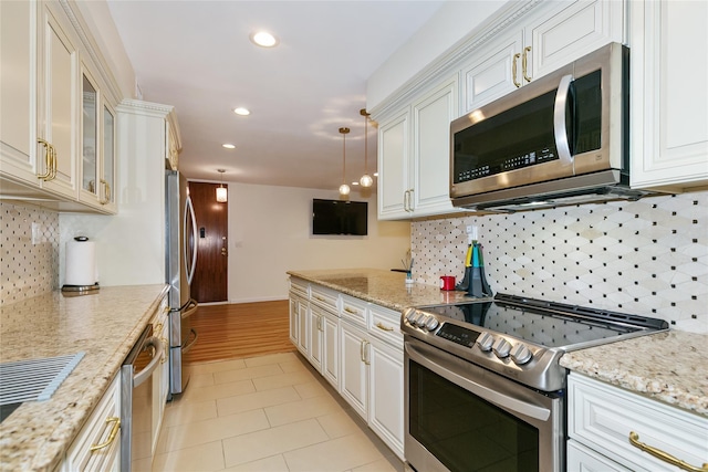171 S Middle Neck Rd Unit 1F, Great Neck, NY 11021 - kitchen with stainless steel appliances, recessed lighting, white cabinets, decorative backsplash, and glass insert cabinets