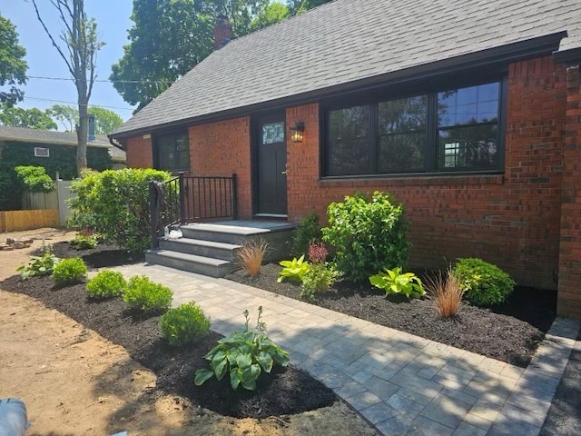 12 Hillside Rd, Deer Park, NY 11729 - view of front of home with brick siding, a chimney, and a shingled roof