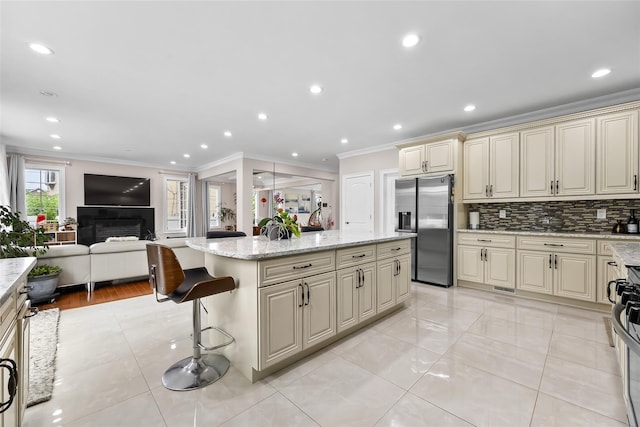 5 Vera Ave, Plainview, NY 11803 - kitchen featuring stainless steel refrigerator with ice dispenser, cream cabinets, open floor plan, crown molding, and a center island