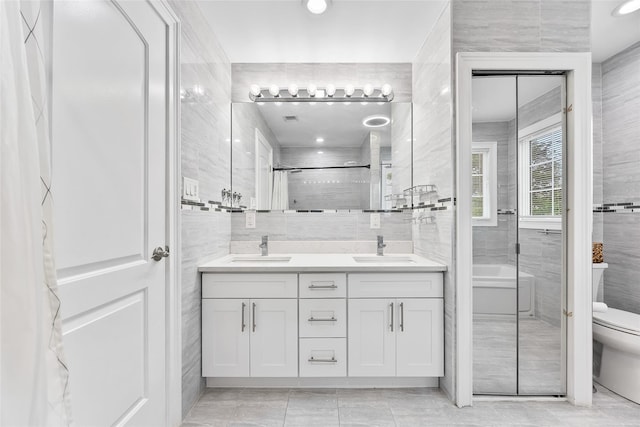 5 Vera Ave, Plainview, NY 11803 - full bath with tile walls, double vanity, a bath, tile patterned floors, and a shower