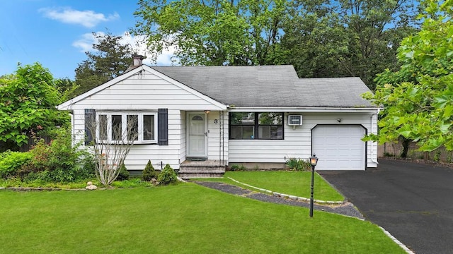 3 Washington Ave, Selden, NY 11784 - view of front of property featuring a garage, asphalt driveway, a front yard, and a shingled roof