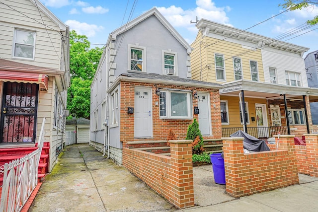 592 E 39th St, Brooklyn, NY 11203 - view of front of house with brick siding, covered porch, and stucco siding