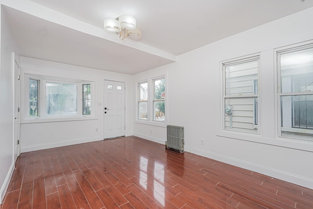592 E 39th St, Brooklyn, NY 11203 - foyer entrance with radiator heating unit, wood finished floors, and a chandelier