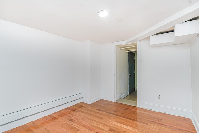 592 E 39th St, Brooklyn, NY 11203 - unfurnished room featuring a baseboard heating unit and light wood finished floors
