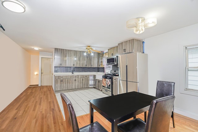 592 E 39th St, Brooklyn, NY 11203 - kitchen featuring appliances with stainless steel finishes, tasteful backsplash, light countertops, a ceiling fan, and light wood-type flooring