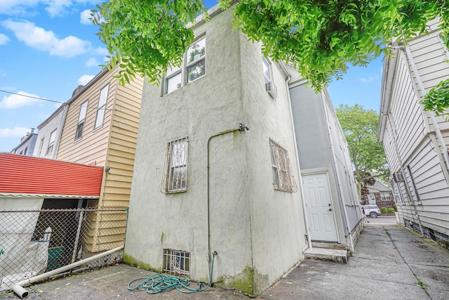 592 E 39th St, Brooklyn, NY 11203 - view of home's exterior featuring stucco siding and a patio