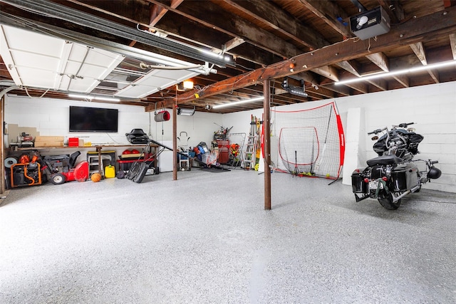 20 Honeymoon Ln, Poughkeepsie, NY 12603 - garage featuring a garage door opener and concrete block wall