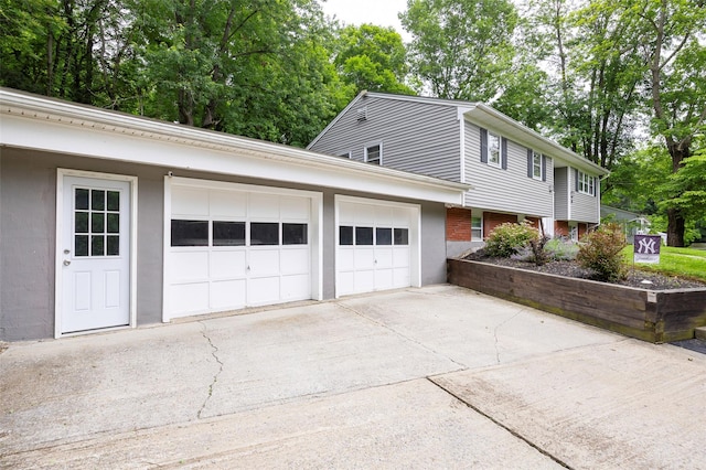 20 Honeymoon Ln, Poughkeepsie, NY 12603 - view of side of property featuring concrete driveway, an attached garage, and brick siding