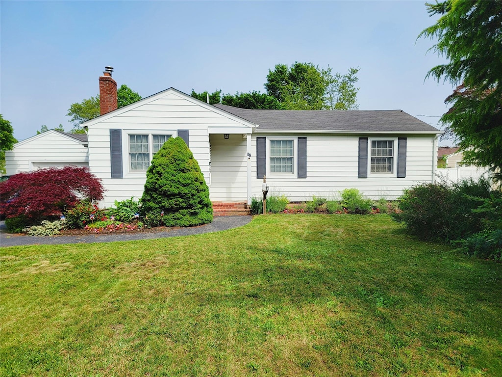 15 Roosevelt Blvd, East Patchogue, NY 11772 - ranch-style house featuring a chimney and a front lawn