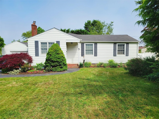 15 Roosevelt Blvd, East Patchogue, NY 11772 - ranch-style house featuring a chimney and a front lawn