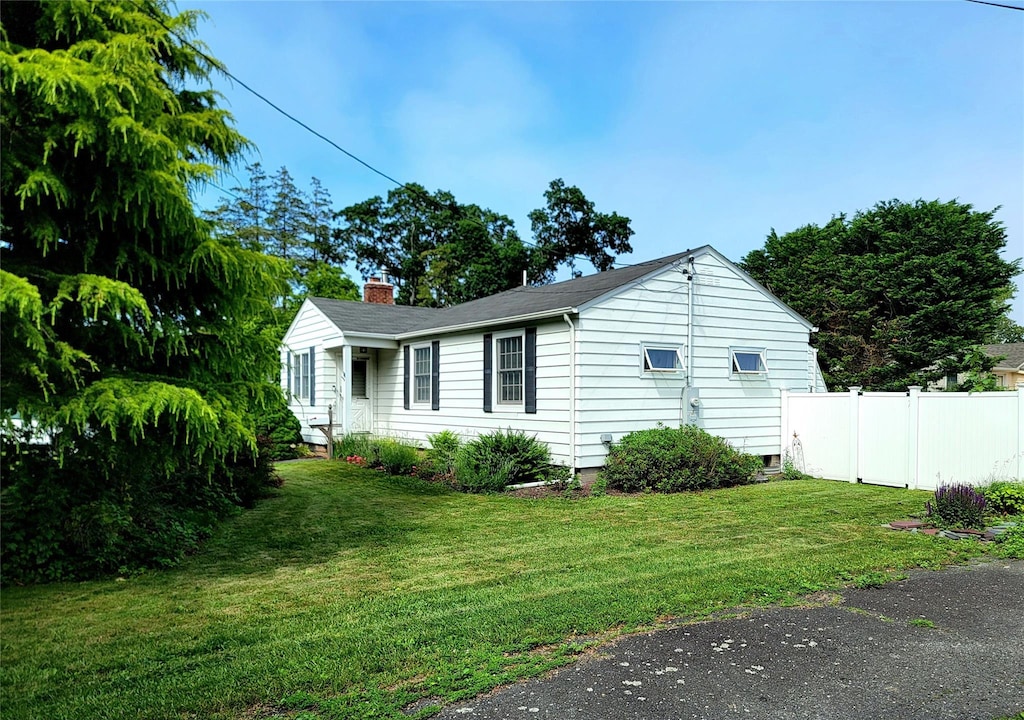 15 Roosevelt Blvd, East Patchogue, NY 11772 - view of side of property featuring a chimney