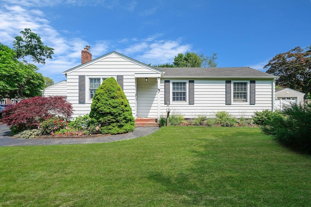 15 Roosevelt Blvd, East Patchogue, NY 11772 - view of front of house with a chimney, a front lawn, and a shingled roof
