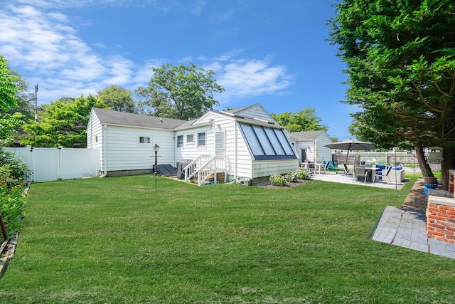 15 Roosevelt Blvd, East Patchogue, NY 11772 - rear view of property featuring a patio, a fenced backyard, and entry steps