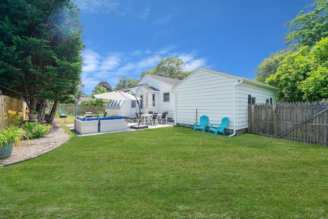 15 Roosevelt Blvd, East Patchogue, NY 11772 - back of property with an outdoor hangout area, a fenced backyard, and a patio area