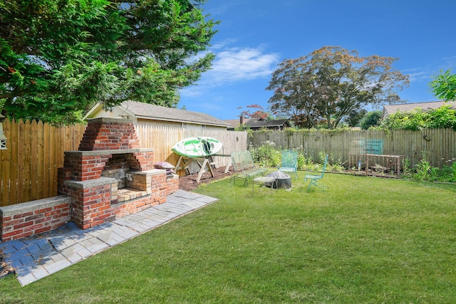 15 Roosevelt Blvd, East Patchogue, NY 11772 - fenced backyard with an outdoor brick fireplace