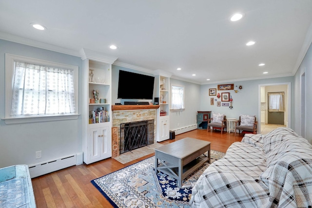 15 Roosevelt Blvd, East Patchogue, NY 11772 - living area featuring a baseboard radiator, recessed lighting, a fireplace with flush hearth, light wood-type flooring, and crown molding