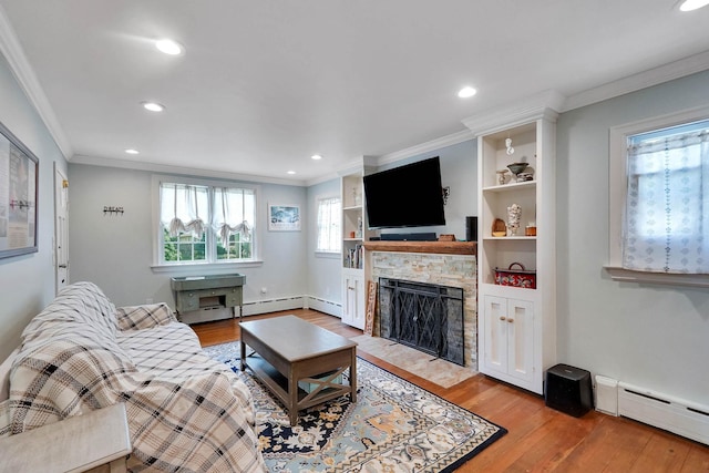 15 Roosevelt Blvd, East Patchogue, NY 11772 - living area with a baseboard heating unit, light wood-style floors, a fireplace, crown molding, and recessed lighting