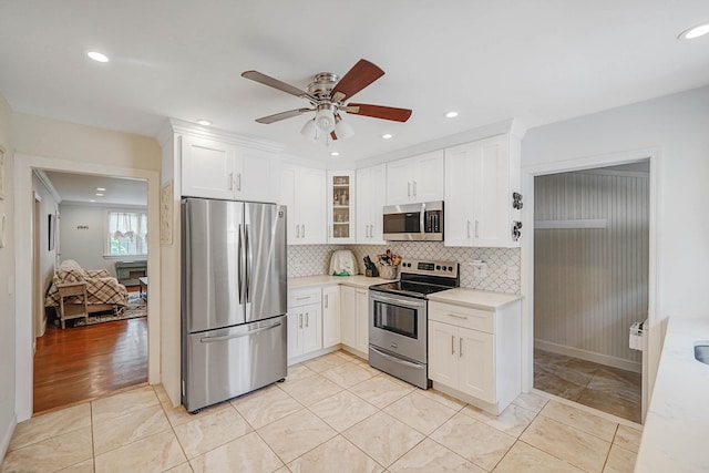 15 Roosevelt Blvd, East Patchogue, NY 11772 - kitchen with stainless steel appliances, a ceiling fan, light countertops, white cabinetry, and recessed lighting
