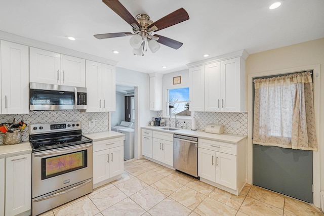 15 Roosevelt Blvd, East Patchogue, NY 11772 - kitchen featuring appliances with stainless steel finishes, washer and dryer, ceiling fan, decorative backsplash, and recessed lighting