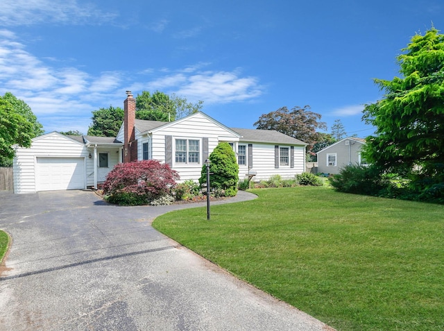 15 Roosevelt Blvd, East Patchogue, NY 11772 - ranch-style house with driveway, a front yard, an attached garage, and a chimney
