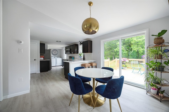 47 Clay Hill Rd, Tivoli, NY 12583 - dining area featuring washing machine and dryer, light wood finished floors, and lofted ceiling