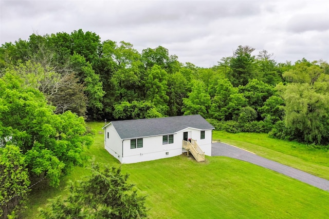 47 Clay Hill Rd, Tivoli, NY 12583 - view of front facade with driveway, a front yard, roof with shingles, and a wooded view