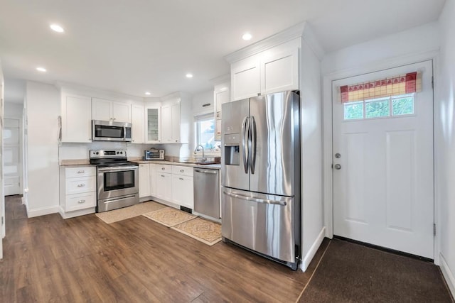 31 Willowood, Wantagh, NY 11793 - kitchen featuring stainless steel appliances, dark wood finished floors, white cabinetry, recessed lighting, and glass insert cabinets