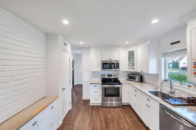 31 Willowood, Wantagh, NY 11793 - kitchen featuring appliances with stainless steel finishes, dark wood finished floors, white cabinets, recessed lighting, and glass insert cabinets