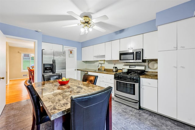 5 Medford Pl, Nanuet, NY 10954 - kitchen with stainless steel appliances, tasteful backsplash, a breakfast bar area, and white cabinetry