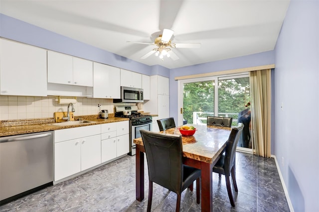5 Medford Pl, Nanuet, NY 10954 - kitchen featuring appliances with stainless steel finishes, white cabinets, decorative backsplash, and ceiling fan
