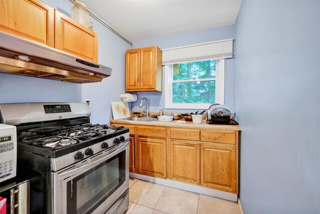 5 Medford Pl, Nanuet, NY 10954 - kitchen featuring stainless steel range with gas stovetop, extractor fan, light countertops, and light tile patterned flooring