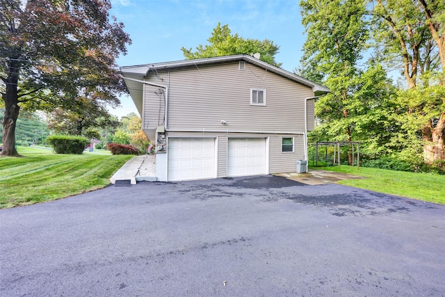 5 Medford Pl, Nanuet, NY 10954 - view of property exterior featuring a lawn, an attached garage, and asphalt driveway