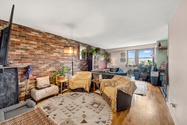 290 W 232nd St Unit 8E, Bronx, NY 10463 - living room featuring light wood finished floors and brick wall