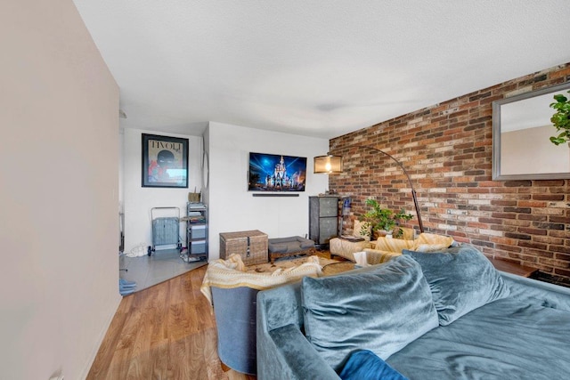 290 W 232nd St Unit 8E, Bronx, NY 10463 - living room with wood finished floors and brick wall