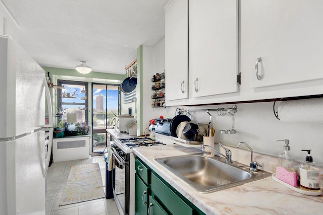 290 W 232nd St Unit 8E, Bronx, NY 10463 - kitchen featuring freestanding refrigerator, range with gas stovetop, green cabinets, light countertops, and radiator